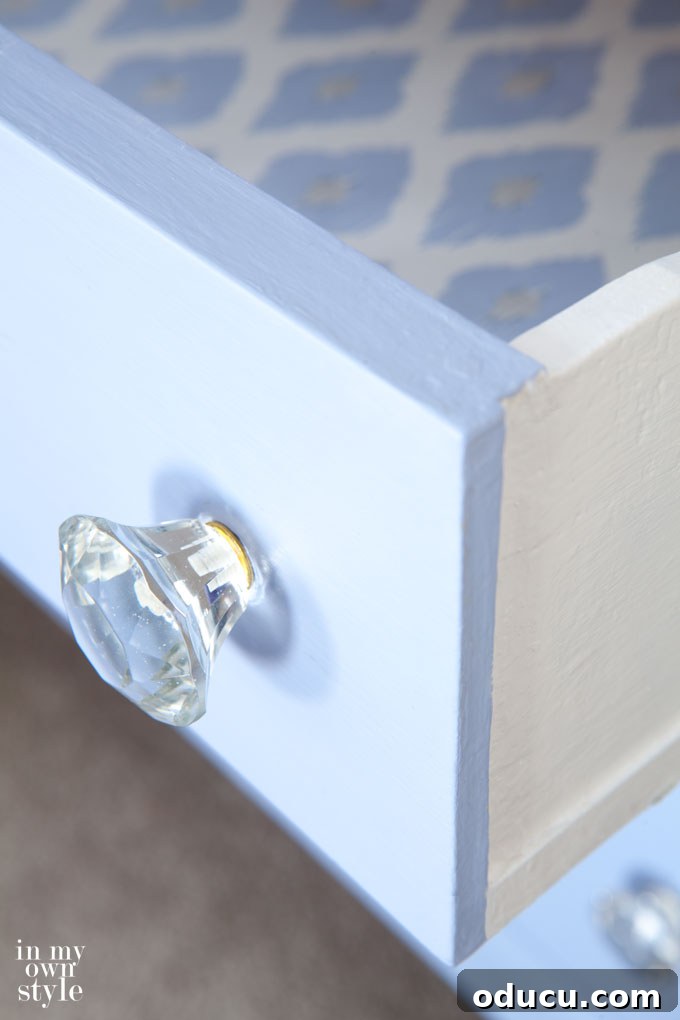 Furniture makeover idea that uses decorative gift wrap to line drawers for a custom look.