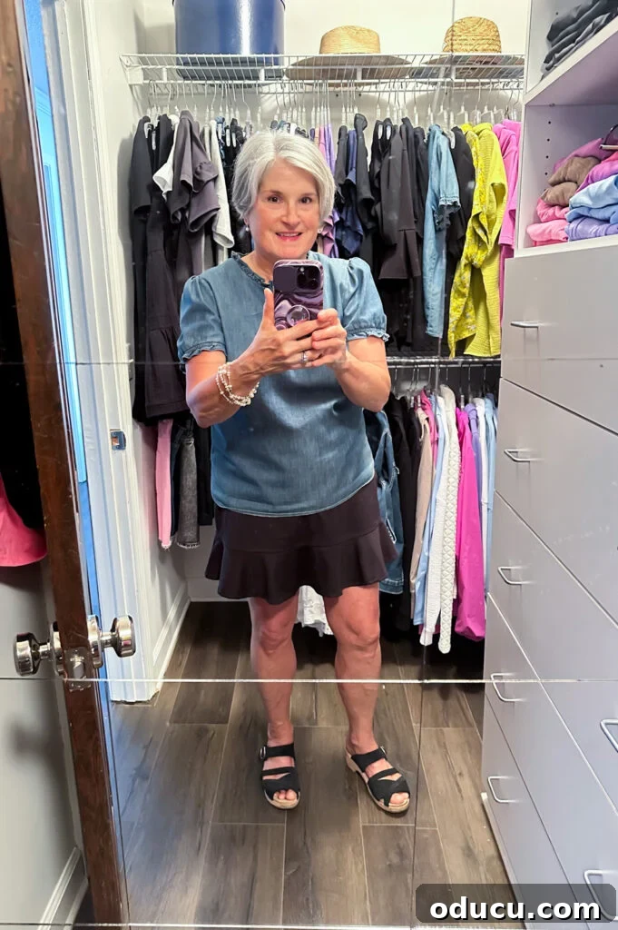 Budget Closet Hacks 15 Blogger, Diane Henkler, standing in her newly cleaned and organized clothes closet