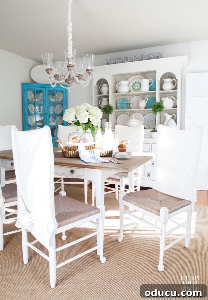 Breathing New Life Into Dining Chairs 14 Dining room decor showcasing a bright and airy aesthetic achieved through decorating with white.