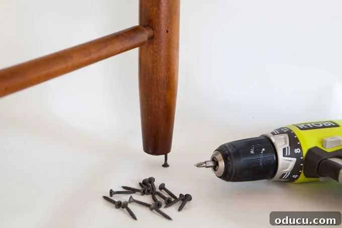 Breathing New Life Into Dining Chairs 6 Clever tip for painting furniture: inserting screws into chair legs to elevate them off the floor for a cleaner finish.