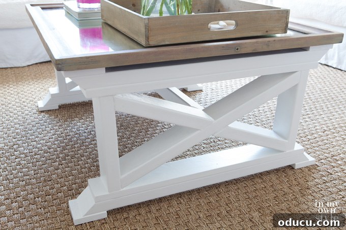 Reborn Reflection Coffee Table 2 Completed X-leg coffee table crafted from a repurposed mirror and 2x4 lumber, showcasing its unique design and finish.