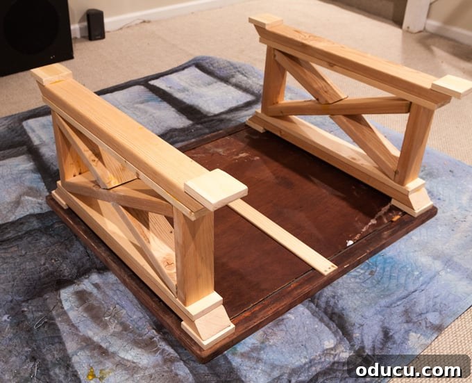 Reborn Reflection Coffee Table 5 Assembling the two side panels of the X-leg coffee table base, ensuring they are identical and stable.