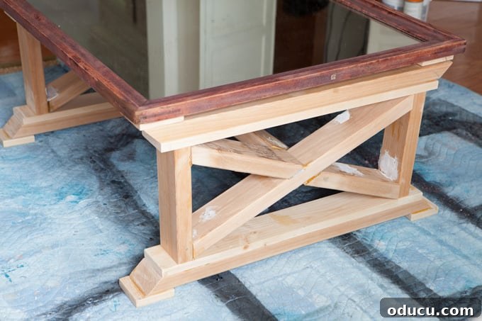 Reborn Reflection Coffee Table 10 Close-up of the mirror frame after paint stripping, revealing the underlying red wood tone before staining.