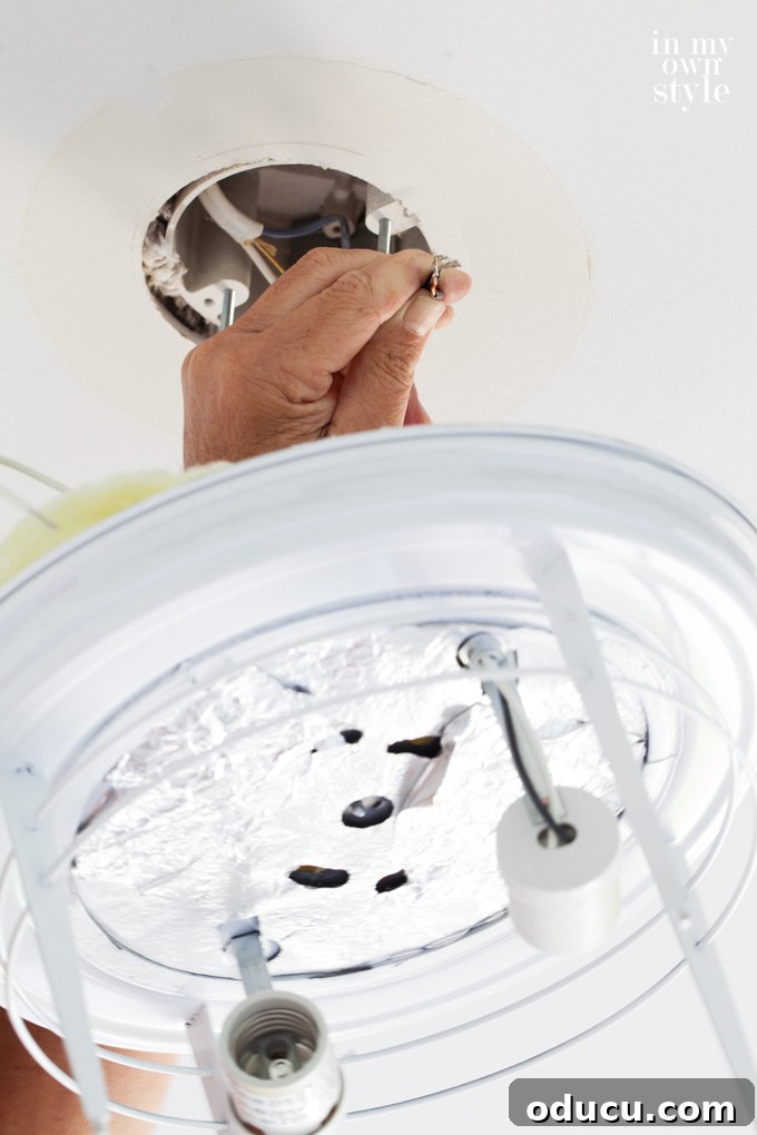Paint Your Ceiling Light Fixture for a Brand New Look 5 Exposed electrical wires in the ceiling box for light fixture wiring