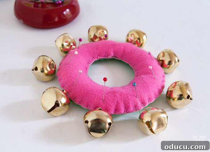 Christmas Door Knob Jingle 5 Stuffed felt ring ready for jingle bells, forming the base of a Christmas door hanger.