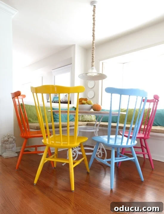 Craft Your Custom Kitchen Banquette 2 DIY kitchen banquette seating with vibrant painted chairs for a lively breakfast nook.