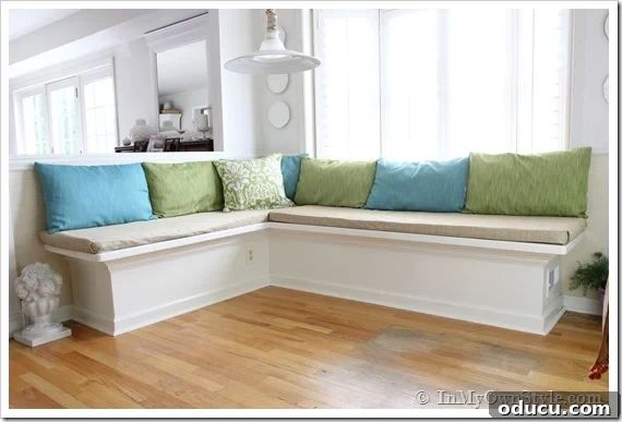 Craft Your Custom Kitchen Banquette 6 A contemporary kitchen banquette featuring new fabric cushions and a stylish table, inviting comfortable dining.