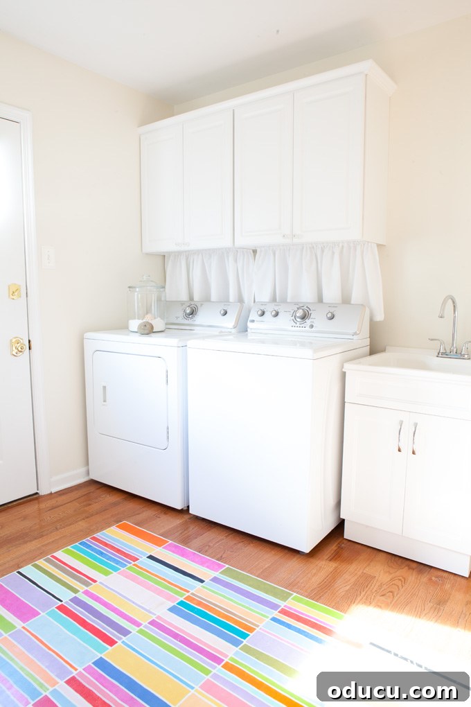 Our Mudroom Transformation with True Value 12 Full laundry room makeover featuring new cabinets and hidden washer dryer connections with curtains