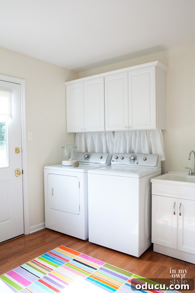 Our Mudroom Transformation with True Value 2 Laundry room after hiding washer and dryer connections with white curtains on tension rods, creating a clean and cohesive look