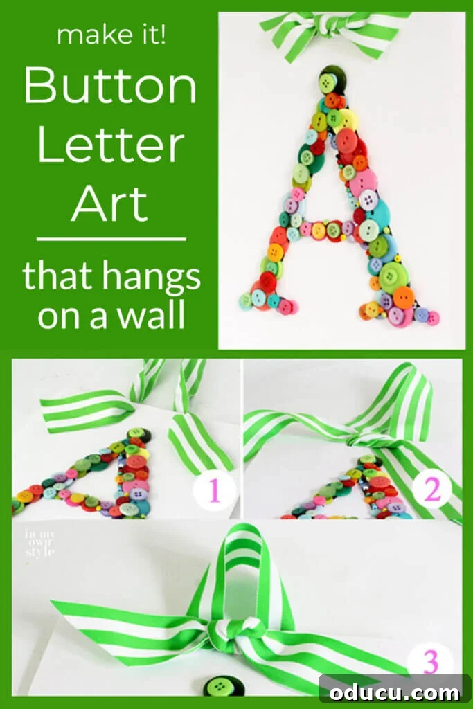 Create Custom Button Letter Wall Art 14 Finished button letter art featuring the letter "A" with a green and white striped ribbon bow hanger, ready for display.
