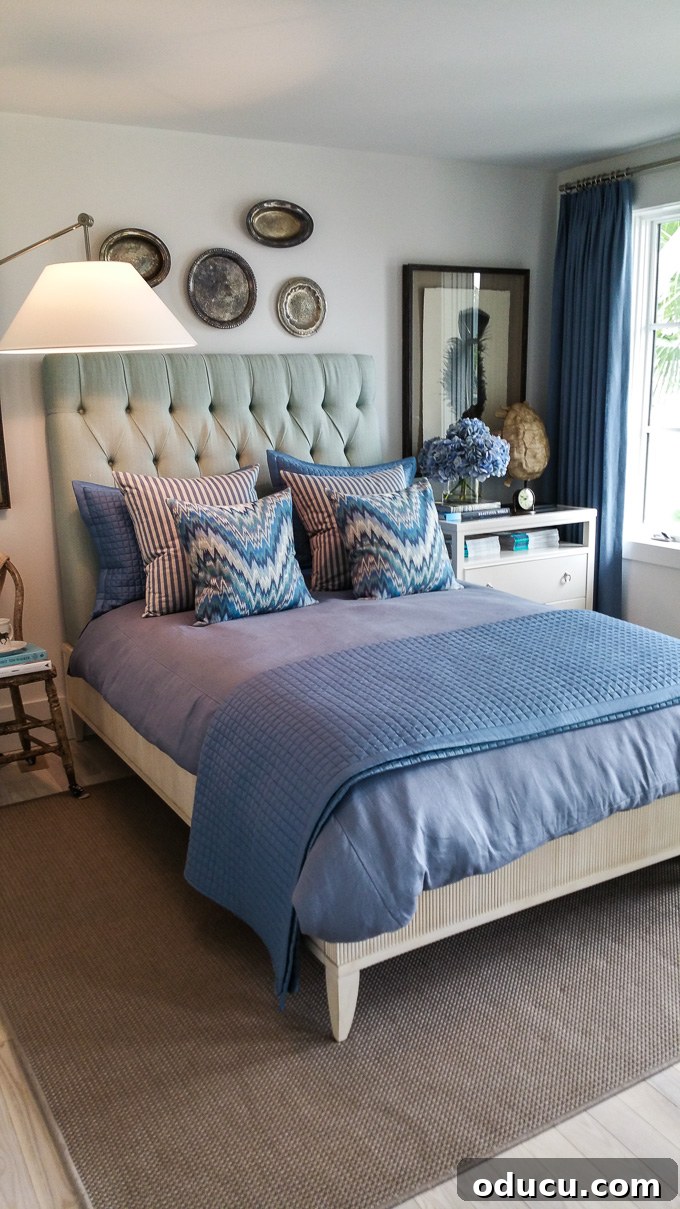 Step Inside the HGTV Dream Home 2016 18 A serene blue bedroom suite in the HGTV Dream Home 2016, featuring a door that opens to stunning water and pool views.