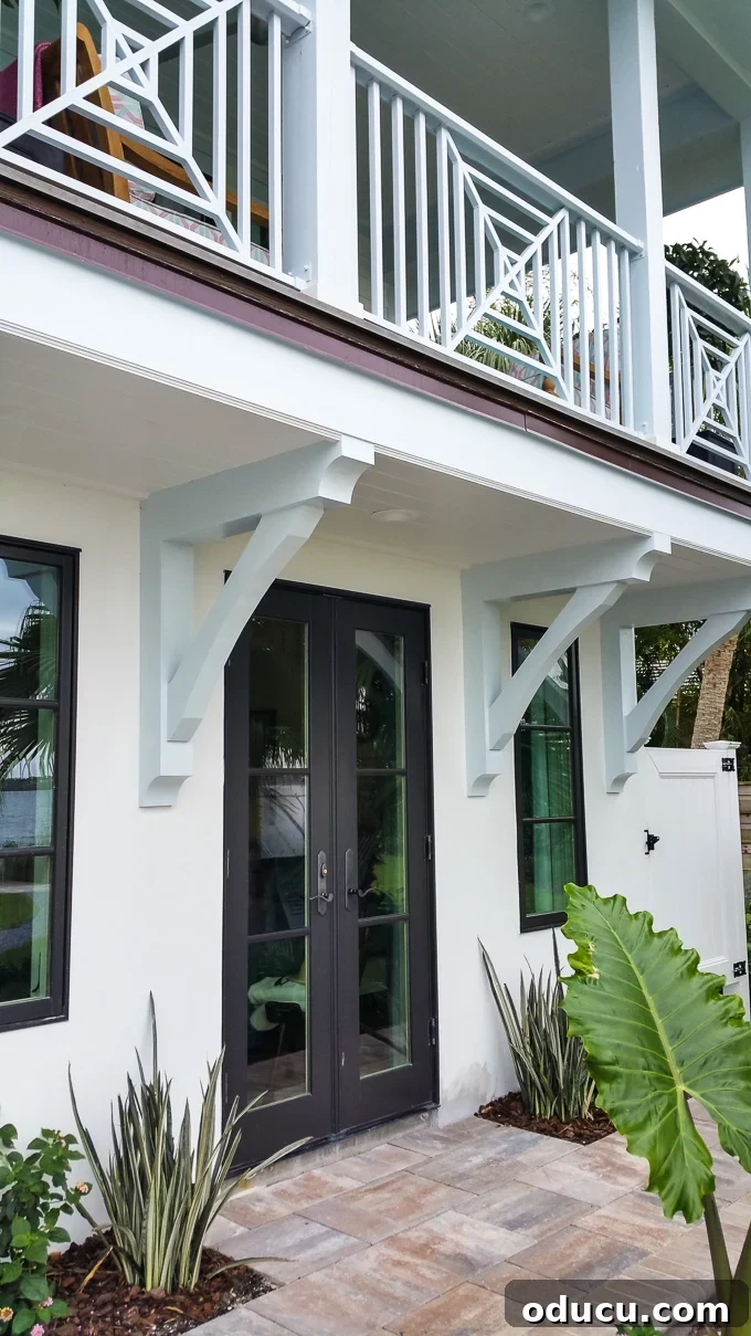 Step Inside the HGTV Dream Home 2016 32 The sophisticated exterior of the HGTV Dream Home 2016, featuring subtle blue accents against a classic white facade.