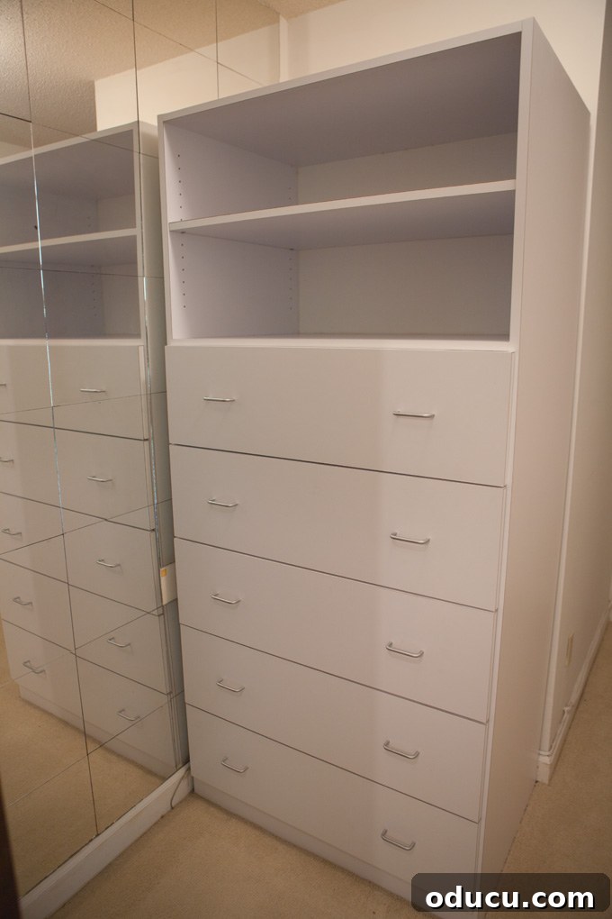A Glimpse Inside My Brand New Home 12 Her walk-in closet in the master bedroom with a chest of drawers and hanging space.