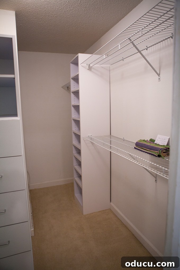 A Glimpse Inside My Brand New Home 13 Full view of a master bedroom closet with clothes neatly arranged on shelves and rods.