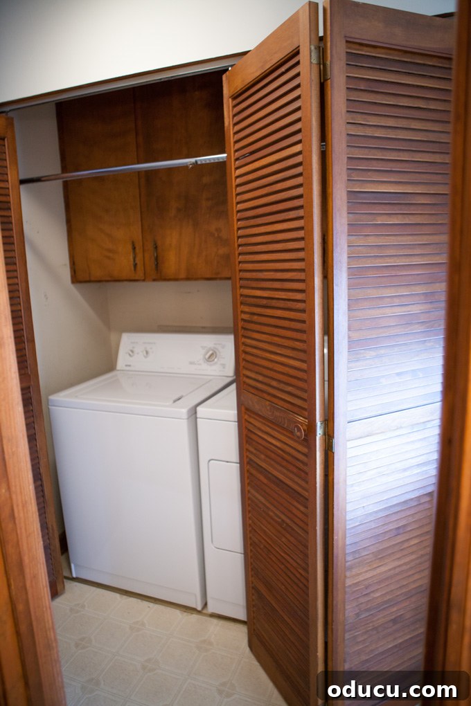 A Glimpse Inside My Brand New Home 20 Laundry room before renovation, showing a washer, dryer, and an unused bar.