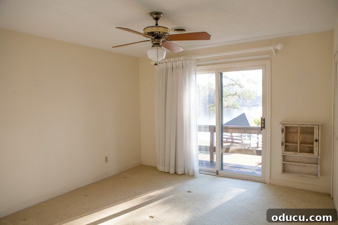 A Glimpse Inside My Brand New Home 24 Upstairs bedroom #1 before renovation with carpet and a window.