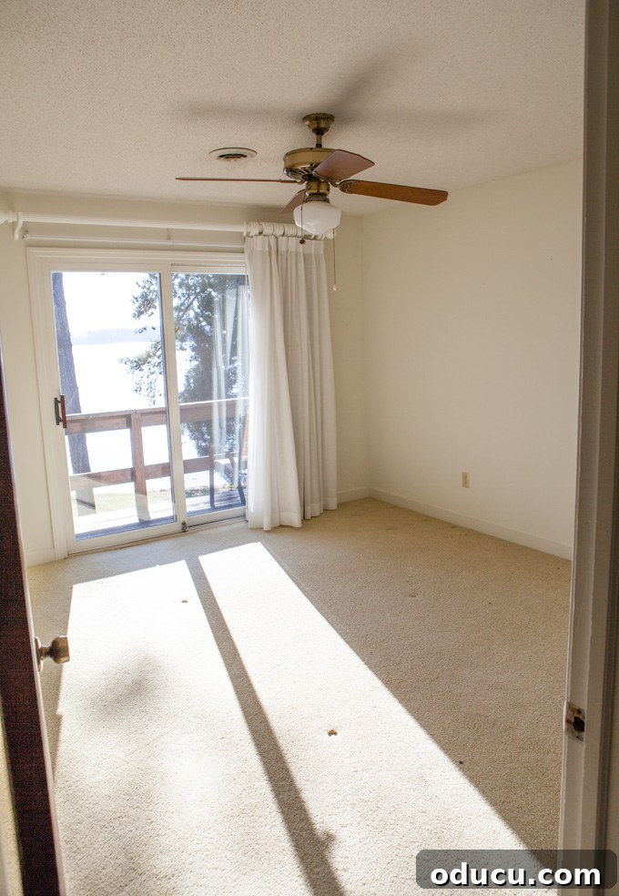 A Glimpse Inside My Brand New Home 25 Upstairs bedroom #2 with a patterned carpet and a window.