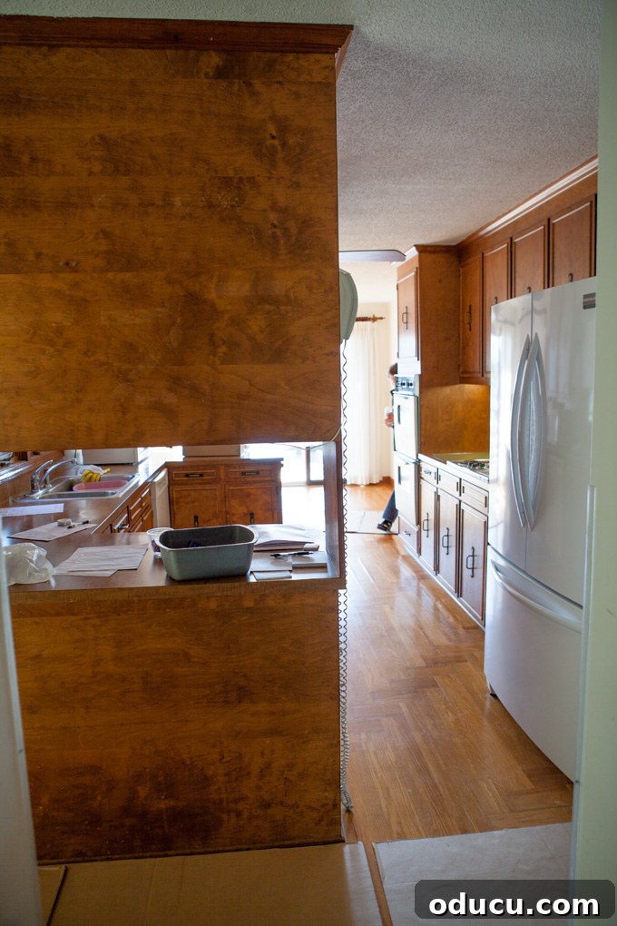 A Glimpse Inside My Brand New Home 9 View of kitchen from garage hallway, showing a wall of brown cabinets blocking the flow.