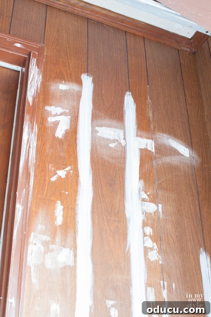 Transform Your Wood Paneling with Paint 2 Tutorial showing how to easily paint wood paneling for a modern home makeover.