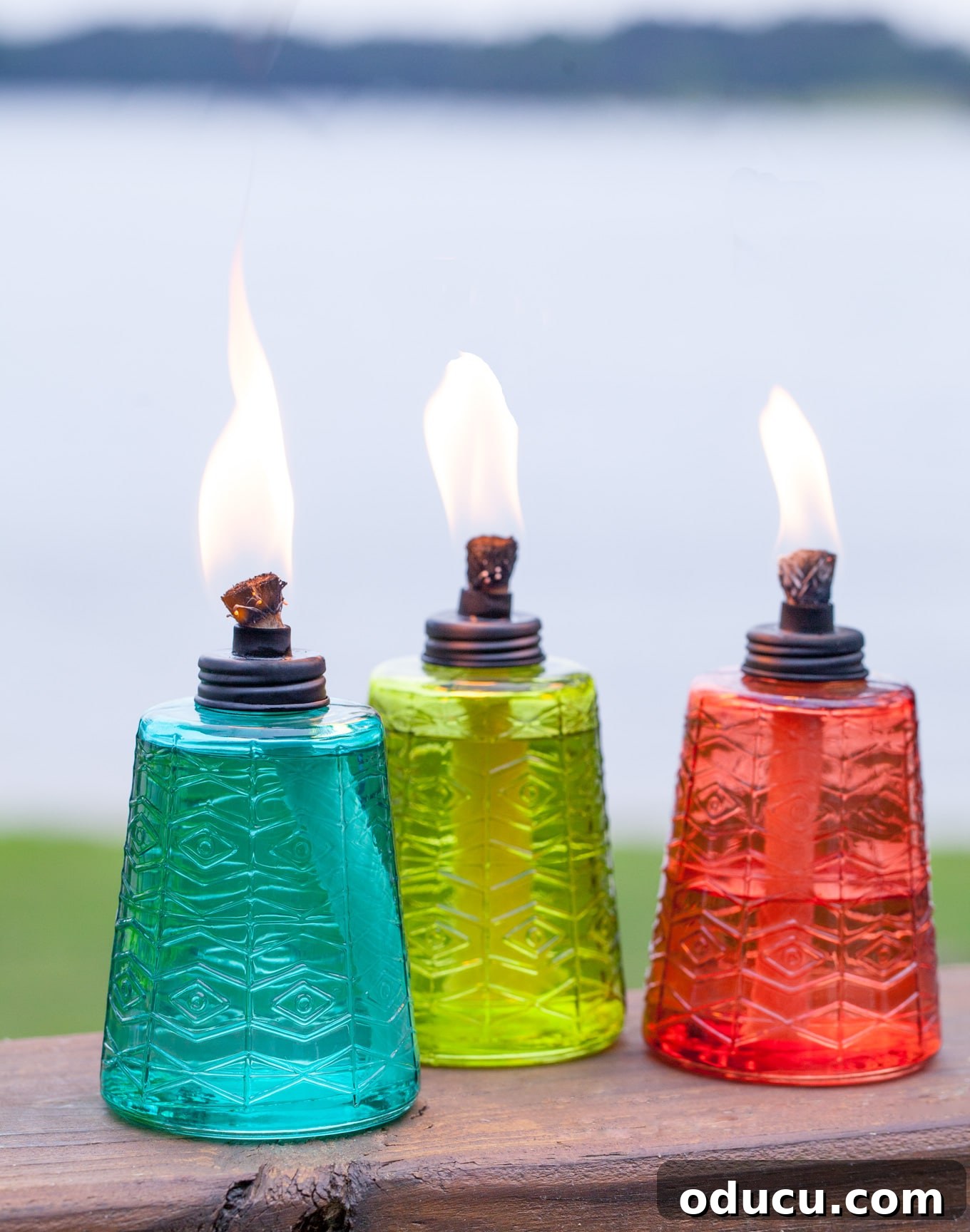 Seamless Outdoor Soirees 7 Elegant molded glass table torches, perfect for adding warm ambient lighting to any outdoor setting.