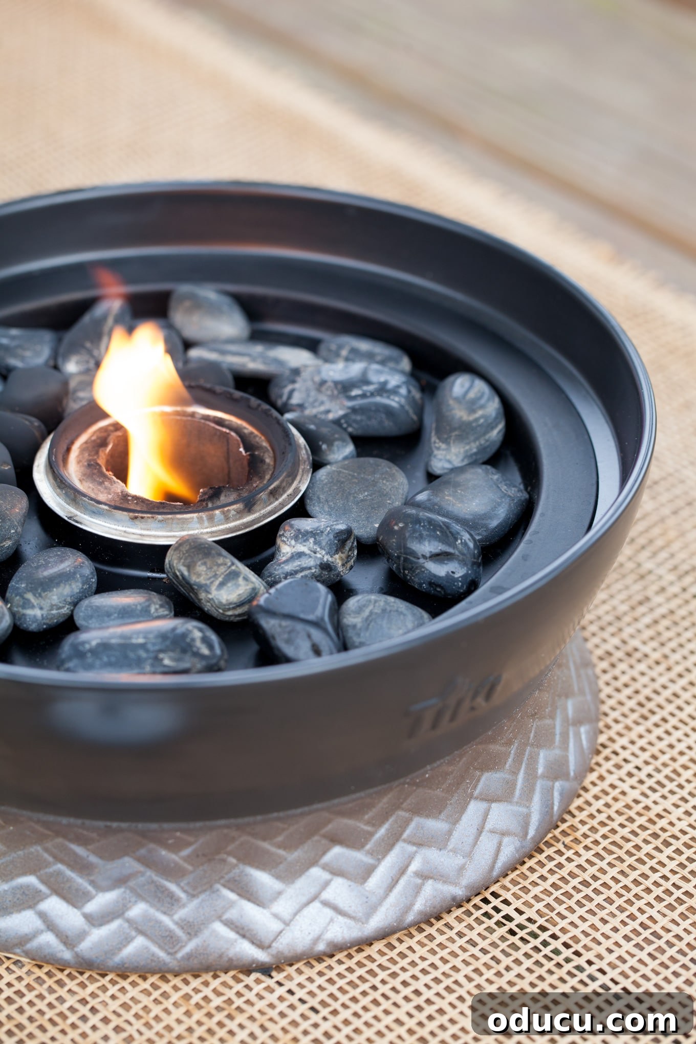 Seamless Outdoor Soirees 6 TIKI Clean Burn tabletop fireplace, providing bright, clean flame and ambiance for outdoor dining.