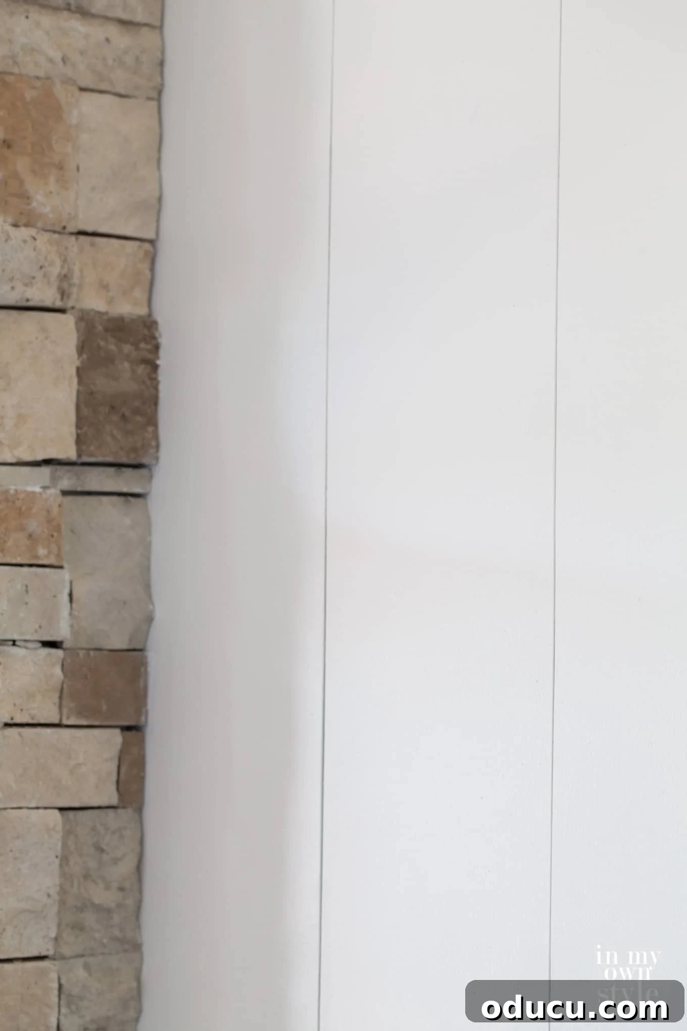 Elevated Vertical Plank Walls 7 DIY vertical plank wall paneling installation showing the use of a level