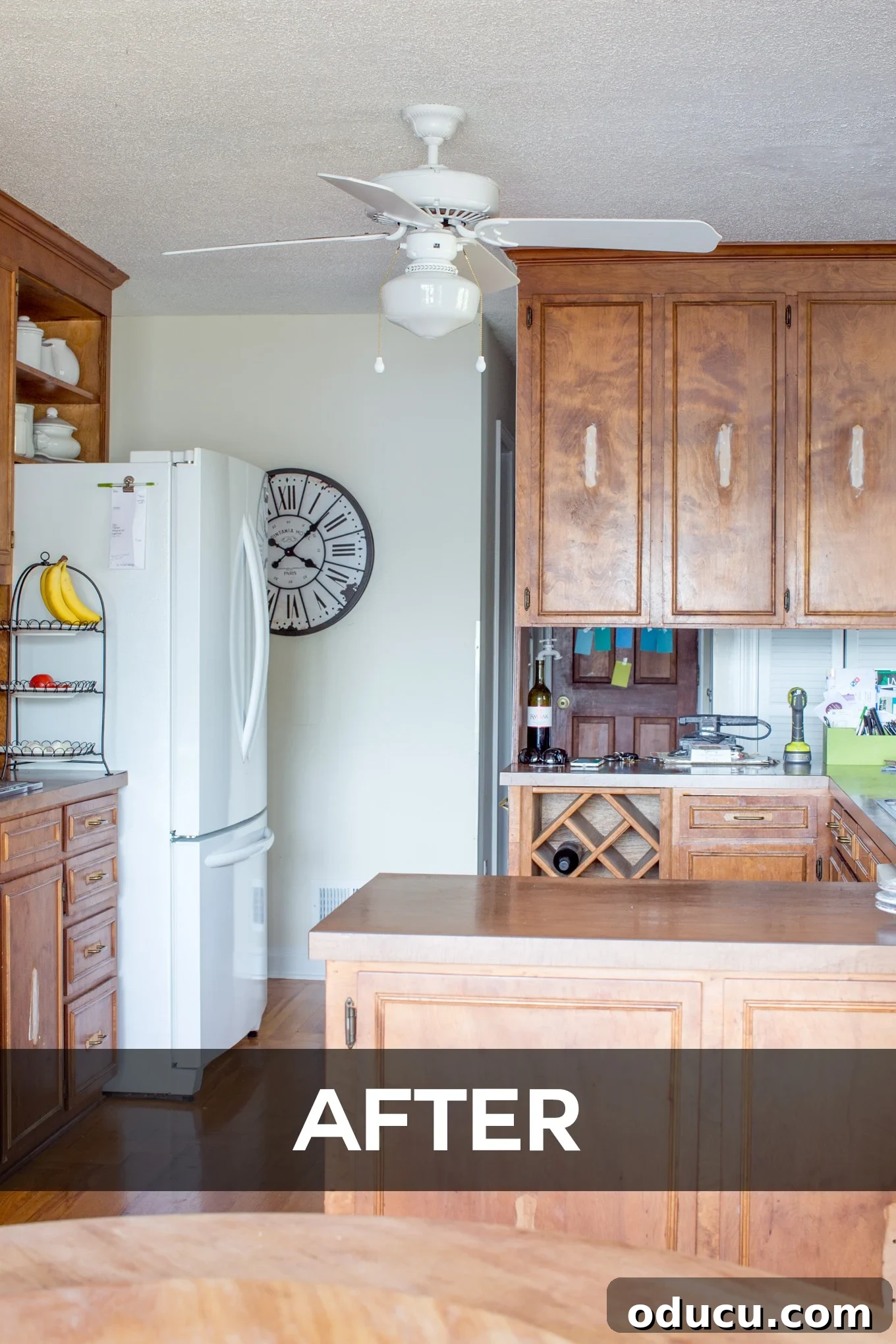 the easy way to upgrade and paint a ceiling fan in your home. Newly painted white ceiling fan in an updated kitchen, blending into the ceiling