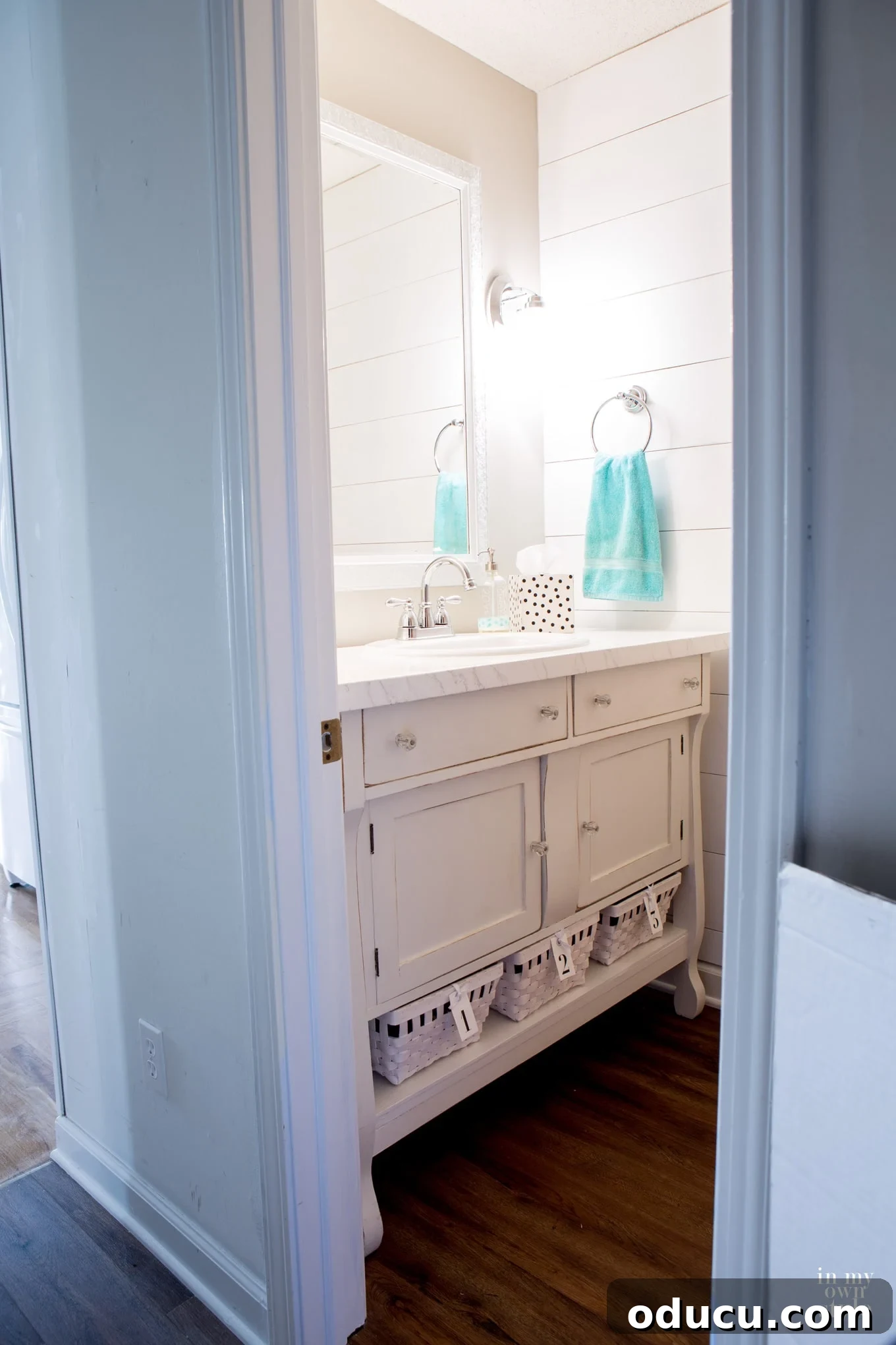 Stunning after photo of a modern, budget-friendly powder room makeover.