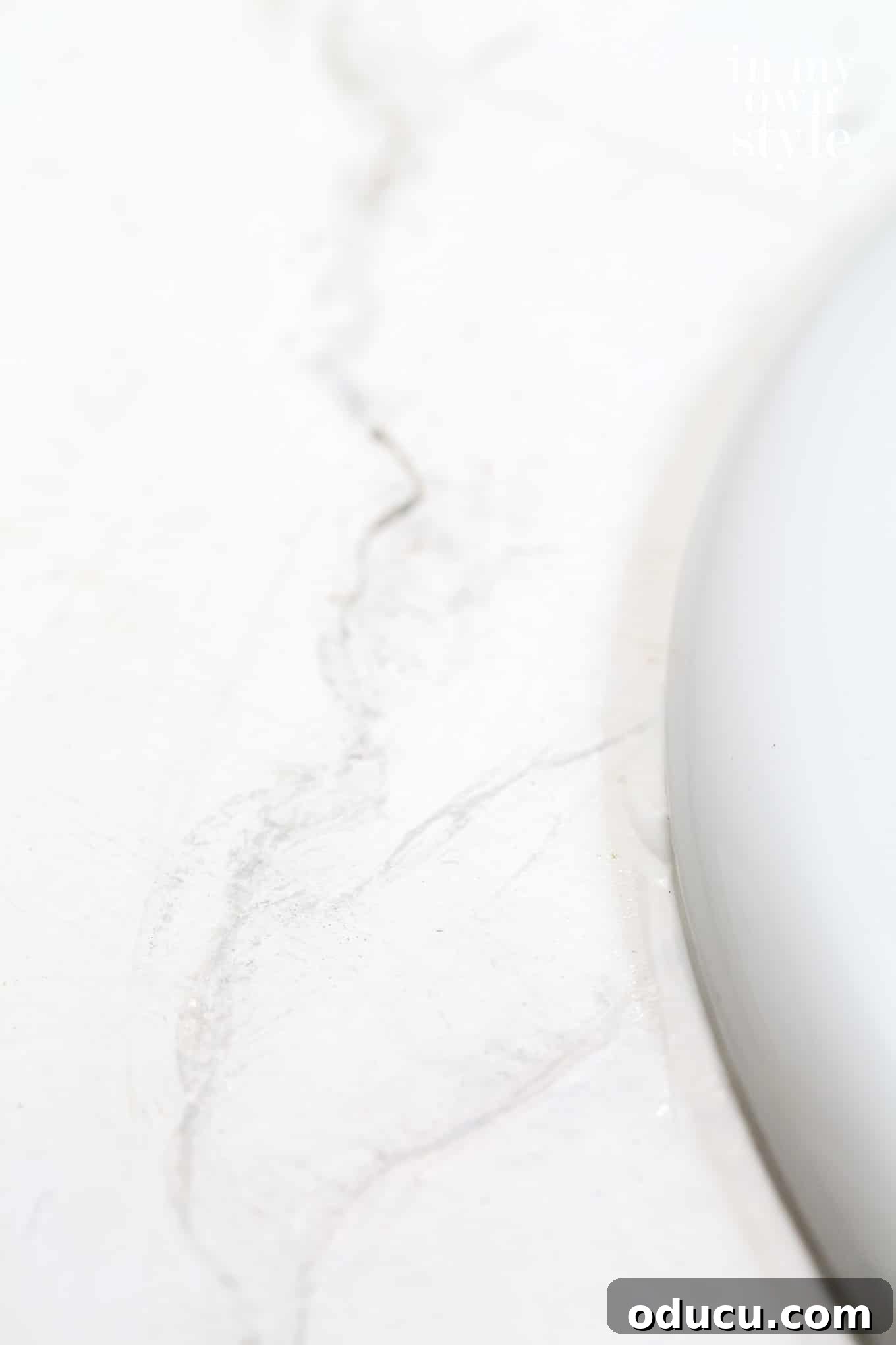 Step-by-step guide on how to paint a bathroom vanity counter with a faux Carrara marble finish.