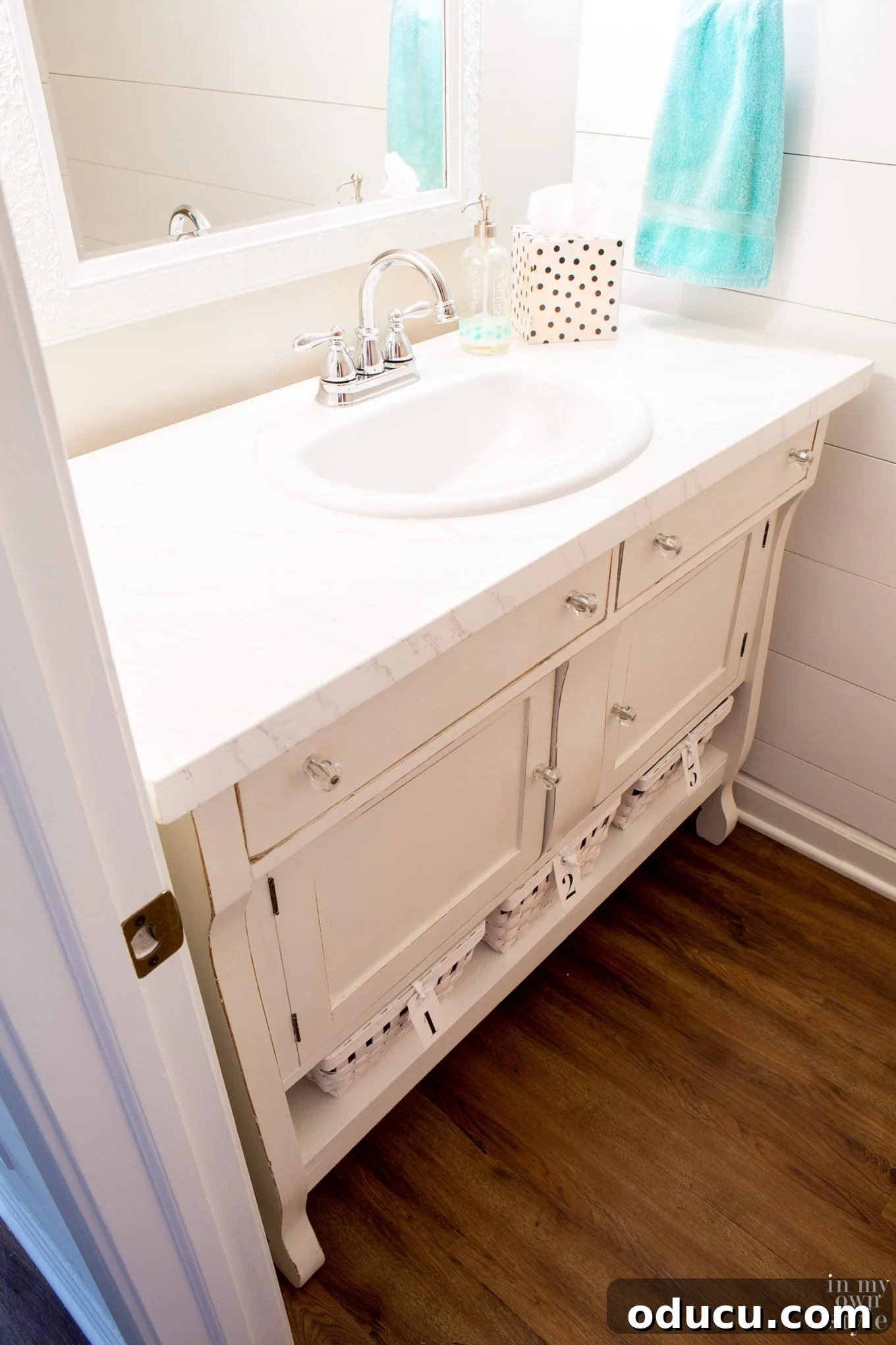 Detailed look at the repurposed sideboard converted into a functional sink vanity for a powder room.