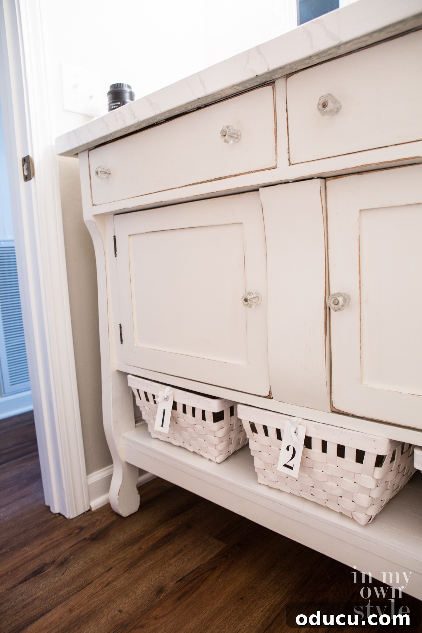 View of the powder room with smart storage solutions, showcasing the finished renovation.