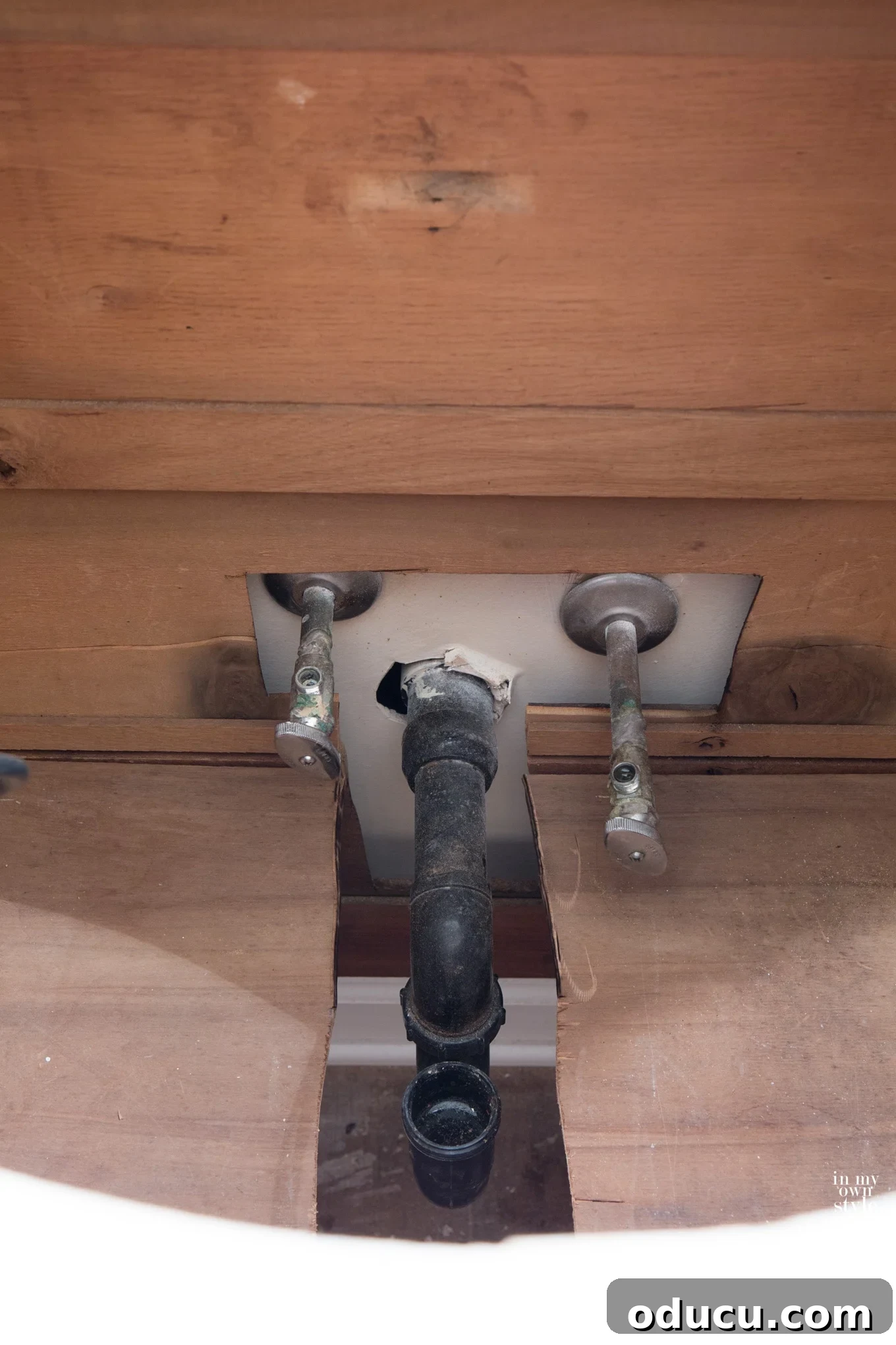 Transforming a Sideboard into a Bathroom Vanity 11 Positioning the repurposed sideboard vanity, aligning with plumbing cutouts