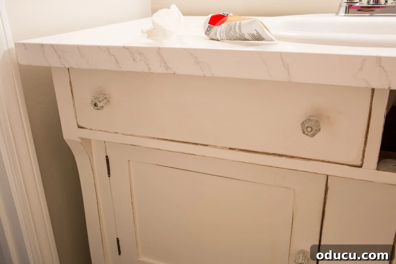 Transforming a Sideboard into a Bathroom Vanity 16 Faux drawer fronts glued into place on the repurposed vanity