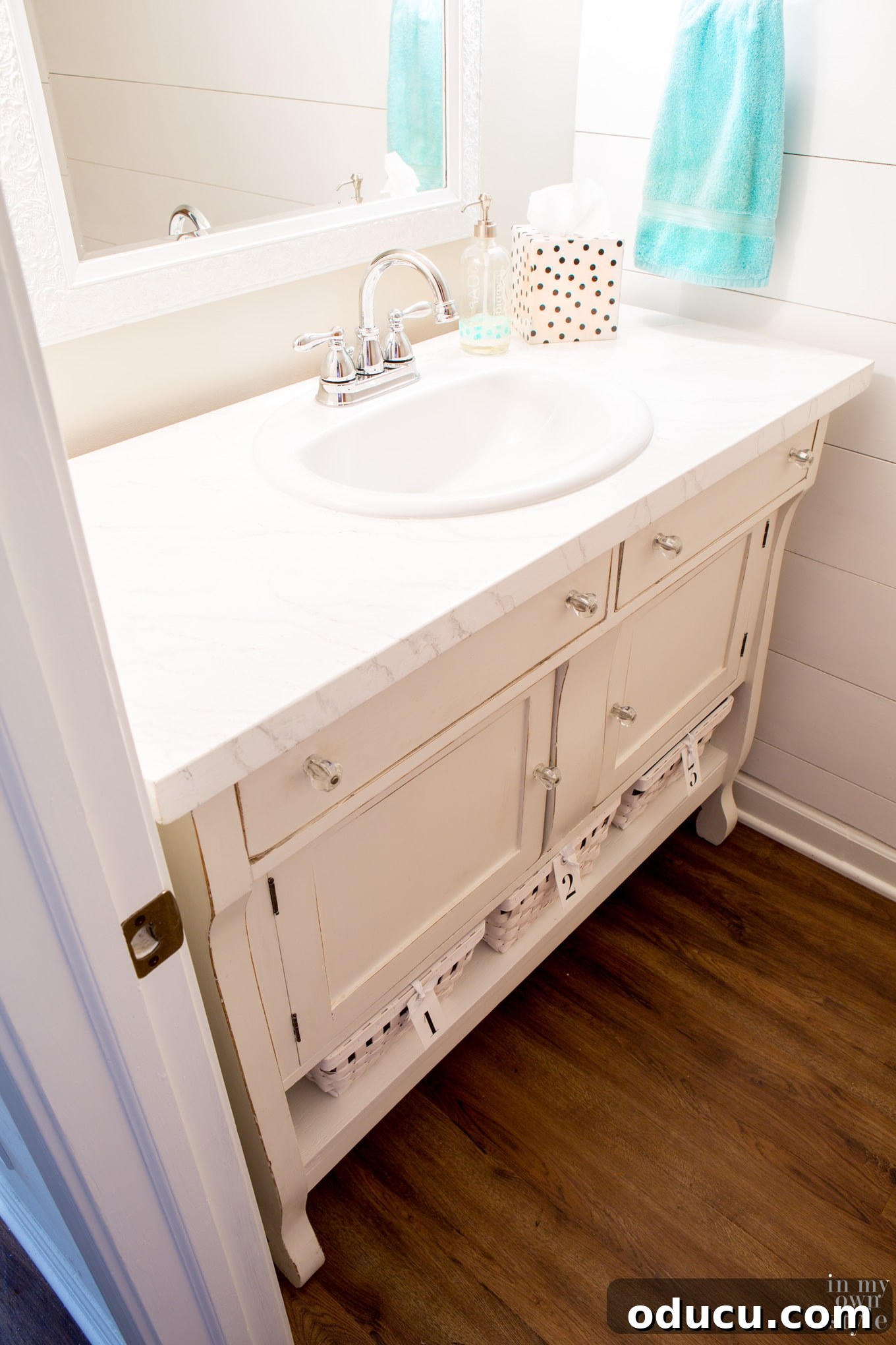 Transforming a Sideboard into a Bathroom Vanity 25 Repurposed sideboard vanity with painted shelf and IKEA baskets