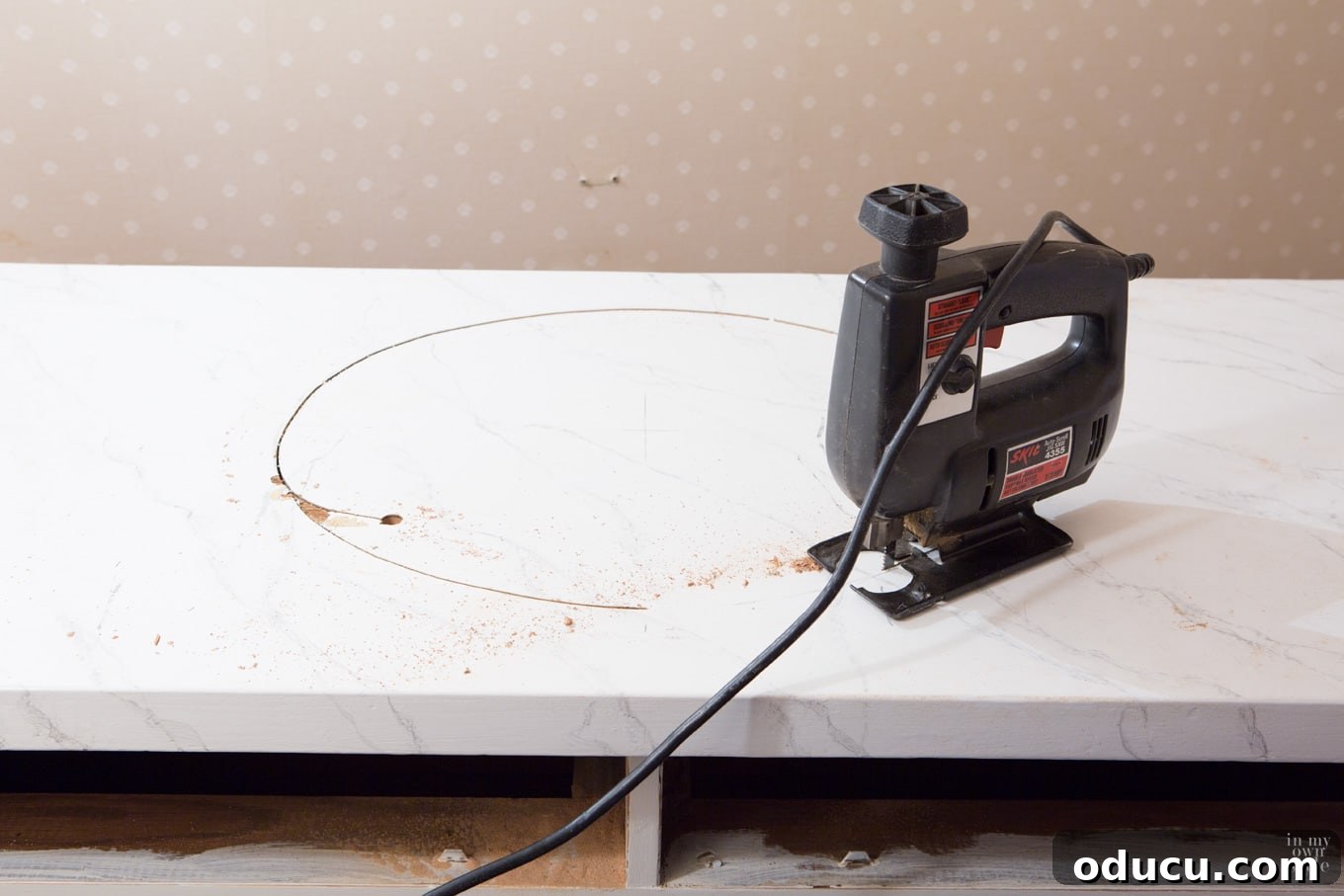 Transforming a Sideboard into a Bathroom Vanity 7 Drilling pilot hole for jigsaw before cutting sink opening