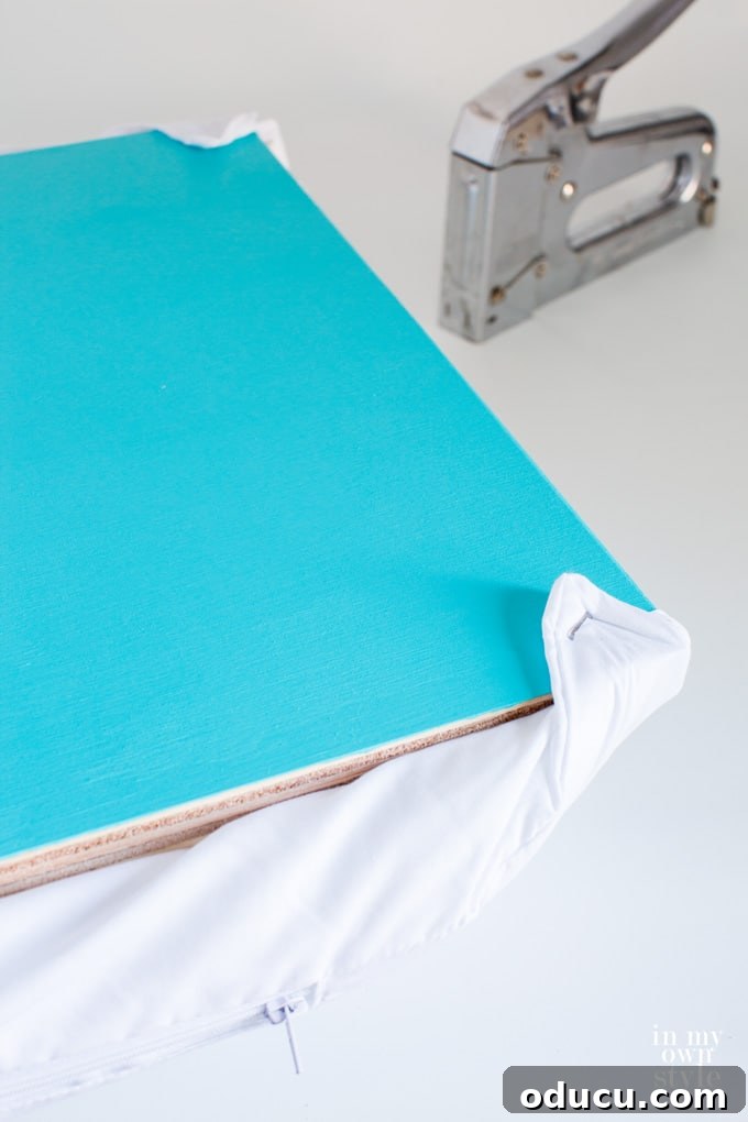 easy to make cushion for a storage crate, showing stapled pillow form corners