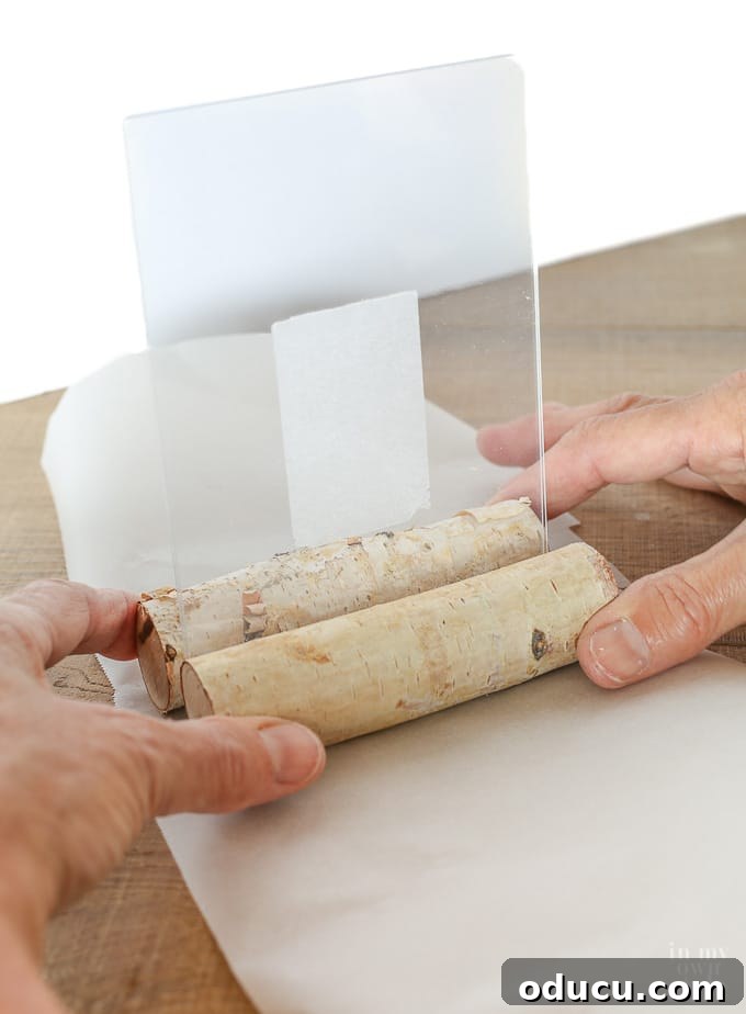 Fall decorating ideas from the dollar store, showing logs being glued to the frame