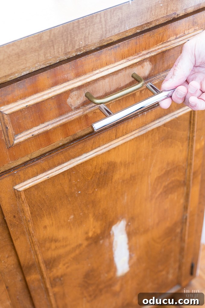 Step-by-step process of replacing kitchen cabinet hardware, showing old pulls being removed.