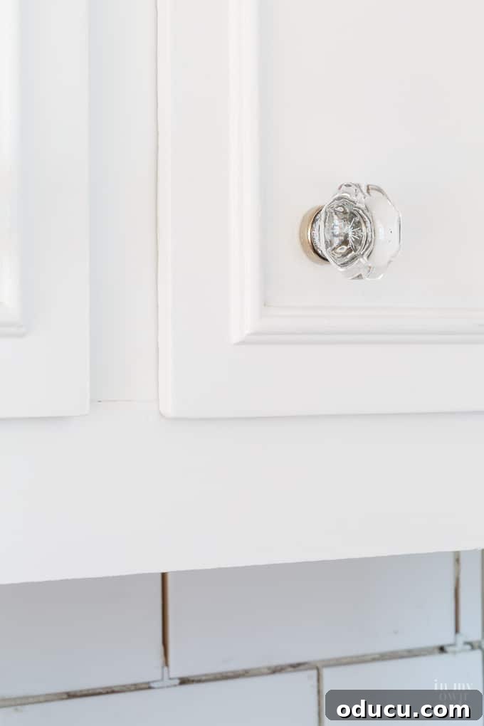 Small Touches, Big Impact: Kitchen Hardware Update 9 Close-up of Cut Glass Cabinet Knobs with Chrome Detail