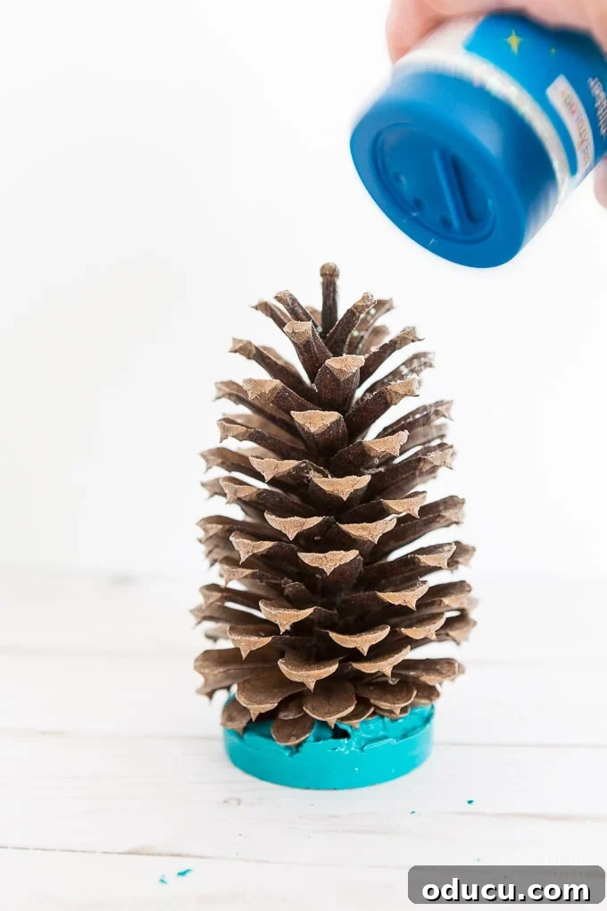 Vibrant Fragrant Holiday Pinecone Creations 13 Generously sprinkling glitter over a glue-coated pine cone for a brilliant, festive look.