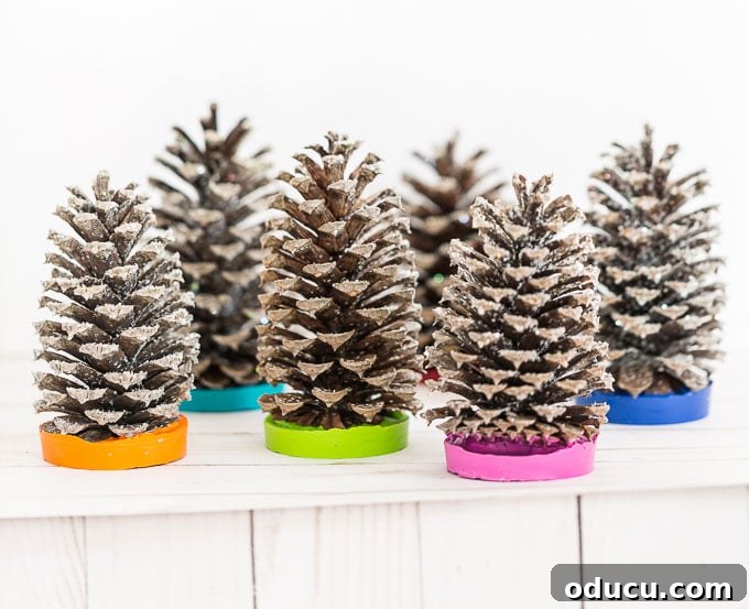 Vibrant Fragrant Holiday Pinecone Creations 21 A collection of beautifully crafted essential oil scented pine cone trees, showcasing various colors, perfect for Christmas decorating and thoughtful holiday gifting.