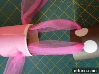 DSCN6396_edited-1 Threading tulle through the punched holes to create the tube hinge.