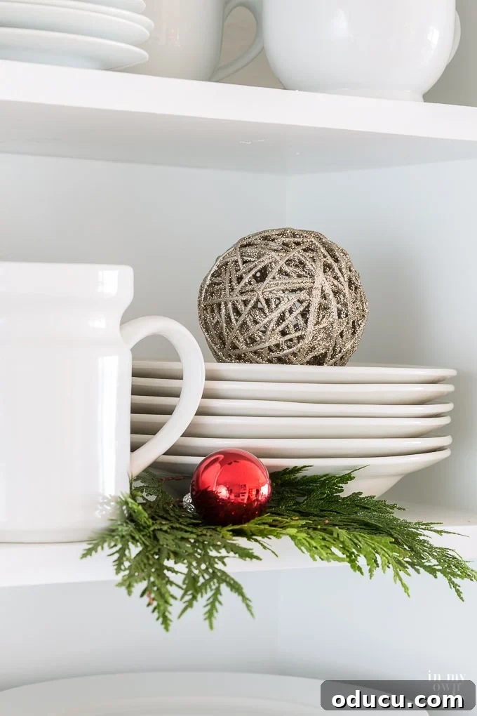 Timeless Christmas Decor with Red White and Greenery 13 kitchen-shelf-christmas-decorating