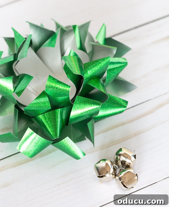Confetti bow styling with jingle bells being prepared for a festive touch