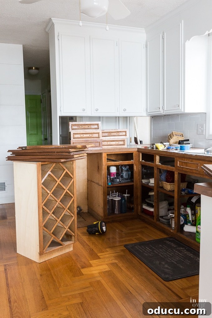Kitchen Remodel: The Home Stretch 3 Before shot of a dark, outdated kitchen with wooden cabinets and old countertops
