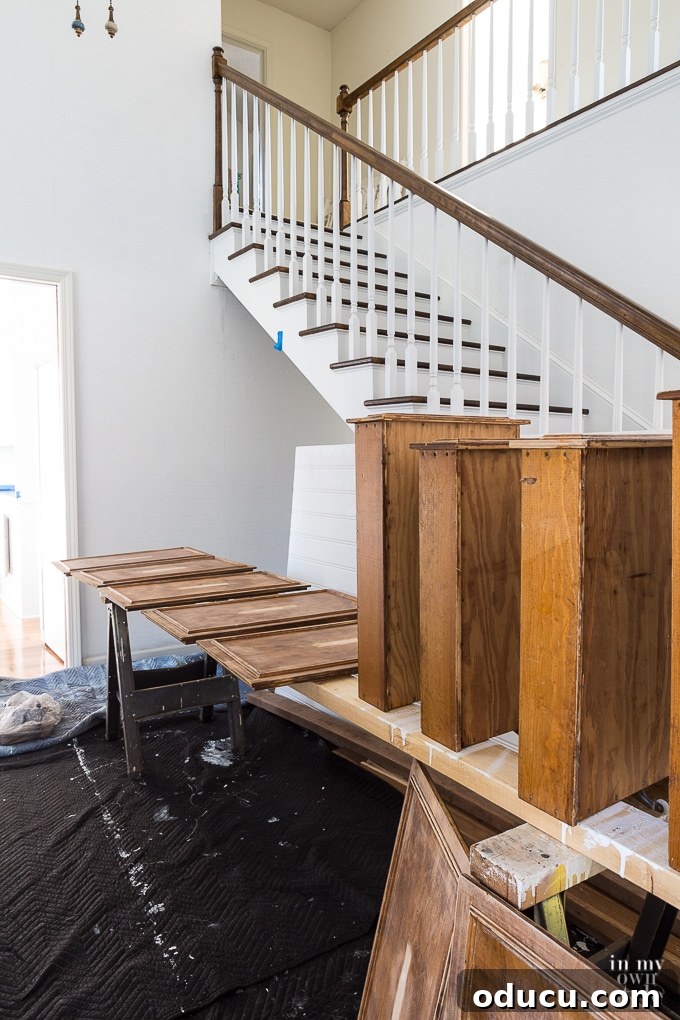 Kitchen Remodel: The Home Stretch 7 Organized indoor setup for painting kitchen cabinet doors in a foyer under a staircase