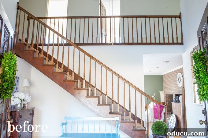 Lake House Living A DIY First Year 14 BEFORE photo of a dark, traditional staircase awaiting a modern makeover