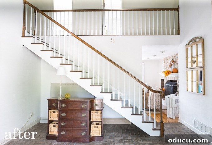 Lake House Living A DIY First Year 15 AFTER photo of a stunning foyer staircase makeover with white balusters