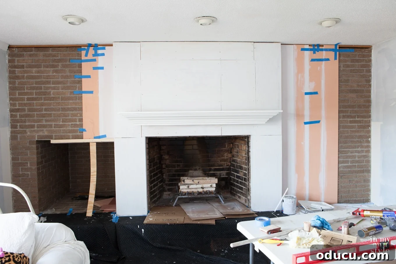 Lake House Living A DIY First Year 17 Before photo of a brick fireplace wall makeover with vertical wood planking