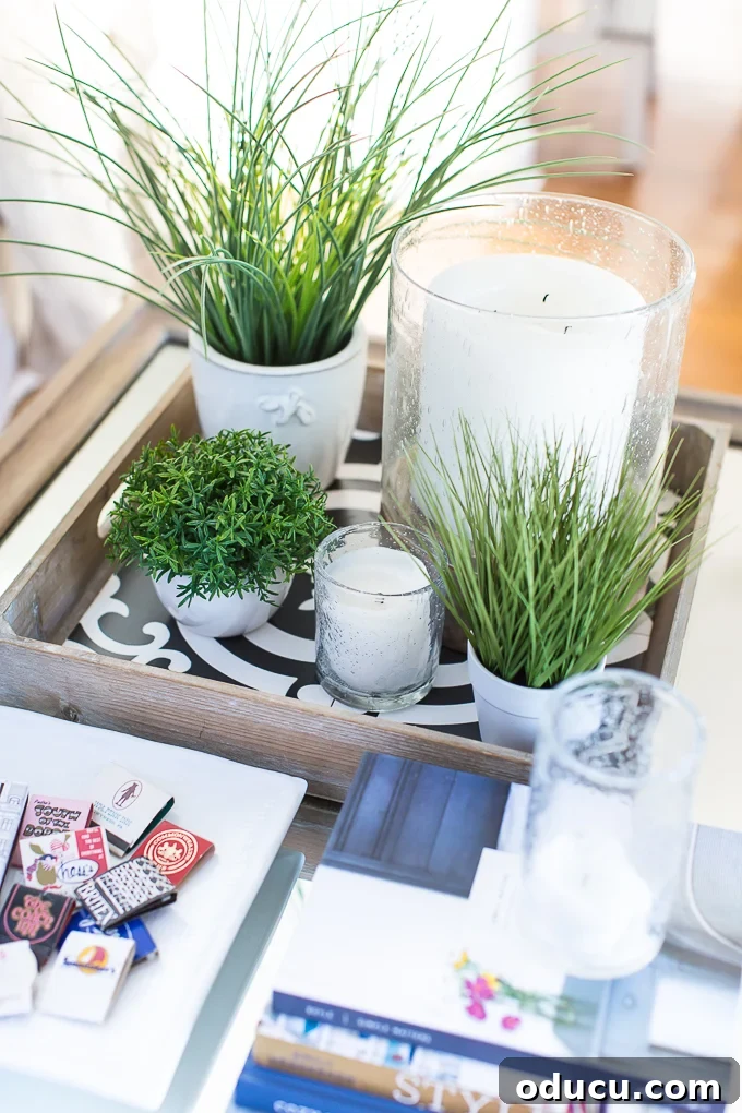 Cozy Winter Interiors: Cultivate Calm and Rejuvenation 13 Faux green plants grouped on a coffee table with bubble glass candle holders